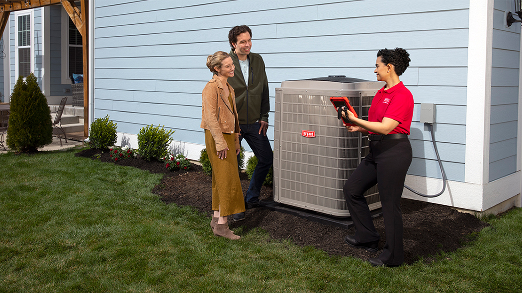 bryant dealer speaking to couple after performing hvac installation