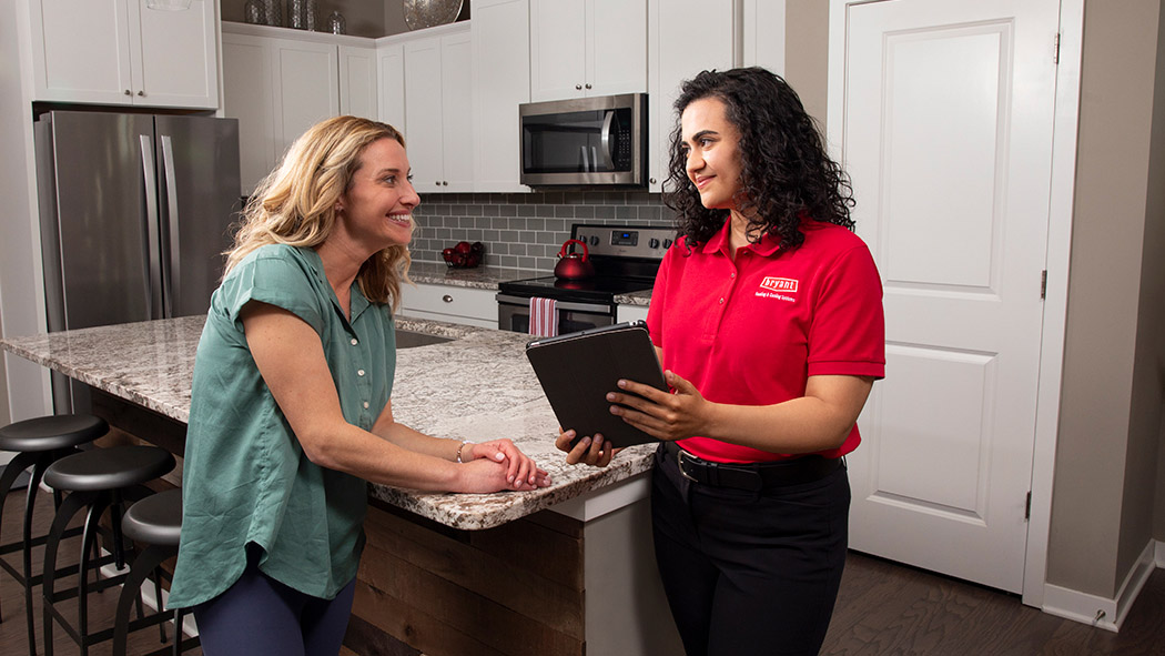 bryant dealer performs an evaluation and estimate with a homeowner