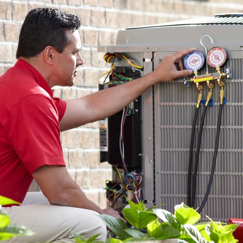 bryant dealer checks gauges while performing annual hvac maintenance